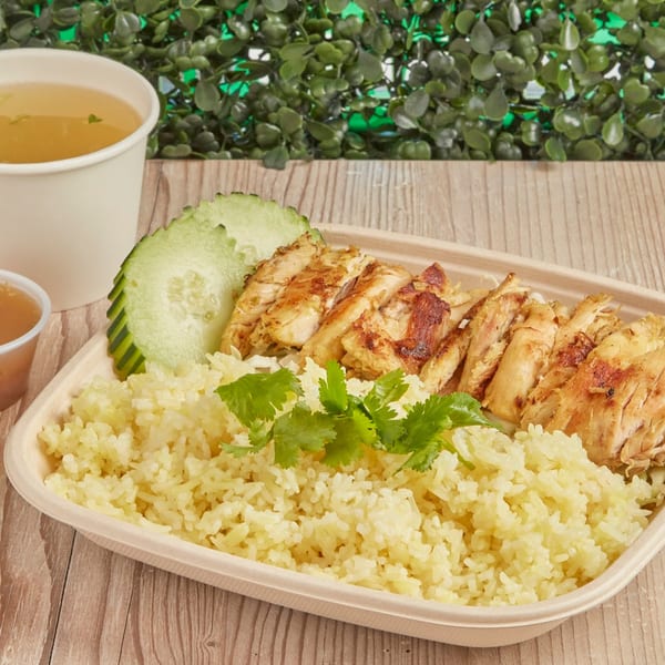 Burd Chicken Rice with grilled chicken, yellow rice, cucumber, cilantro, soup, and sauce.